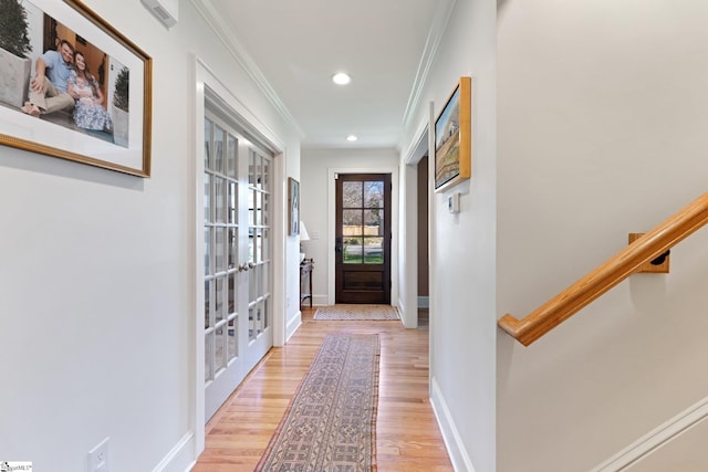 entryway with ornamental molding, recessed lighting, light wood-style flooring, and baseboards