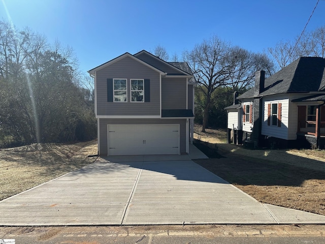 view of side of property featuring a garage and concrete driveway