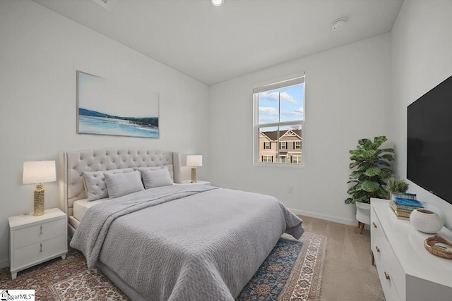 bedroom with vaulted ceiling and baseboards