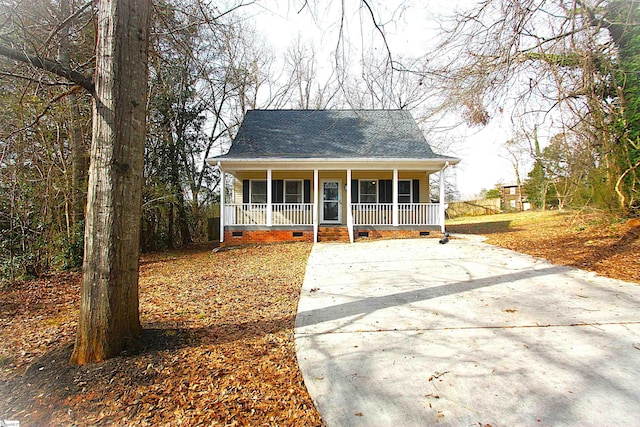 view of front of home featuring crawl space, a porch, and roof with shingles