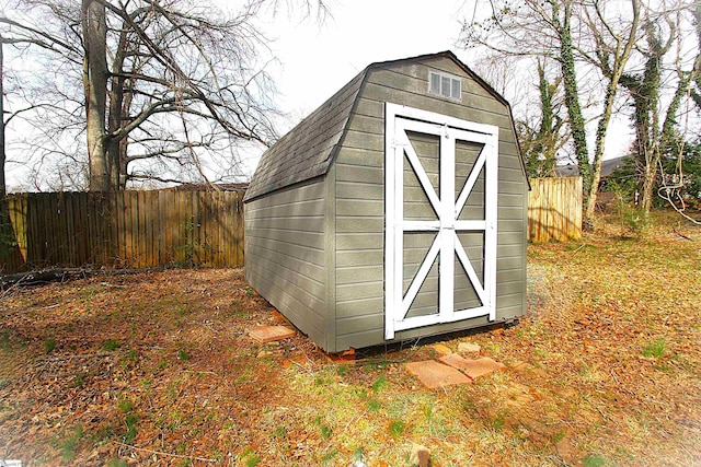 view of shed with fence