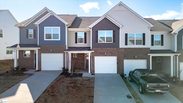 view of front facade featuring an attached garage, driveway, and brick siding