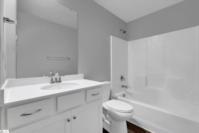 full bath featuring  shower combination, toilet, wood finished floors, and vanity