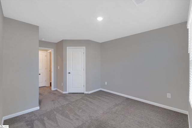 empty room with light carpet, baseboards, and recessed lighting