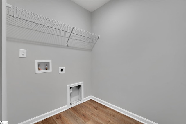 laundry area featuring washer hookup, hookup for an electric dryer, wood finished floors, laundry area, and baseboards