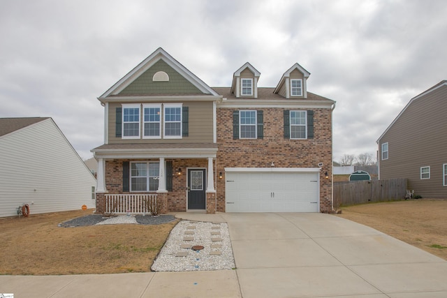 128 Lake Grove Rd, Simpsonville, SC 29681 - craftsman house featuring a porch, an attached garage, brick siding, fence, and driveway