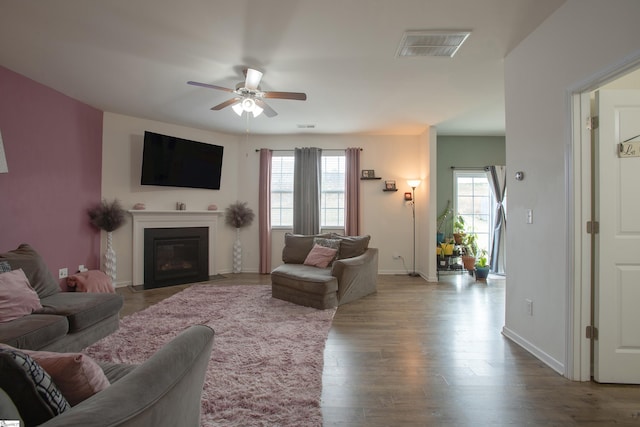 128 Lake Grove Rd, Simpsonville, SC 29681 - living room with a fireplace with flush hearth, wood finished floors, baseboards, visible vents, and a ceiling fan