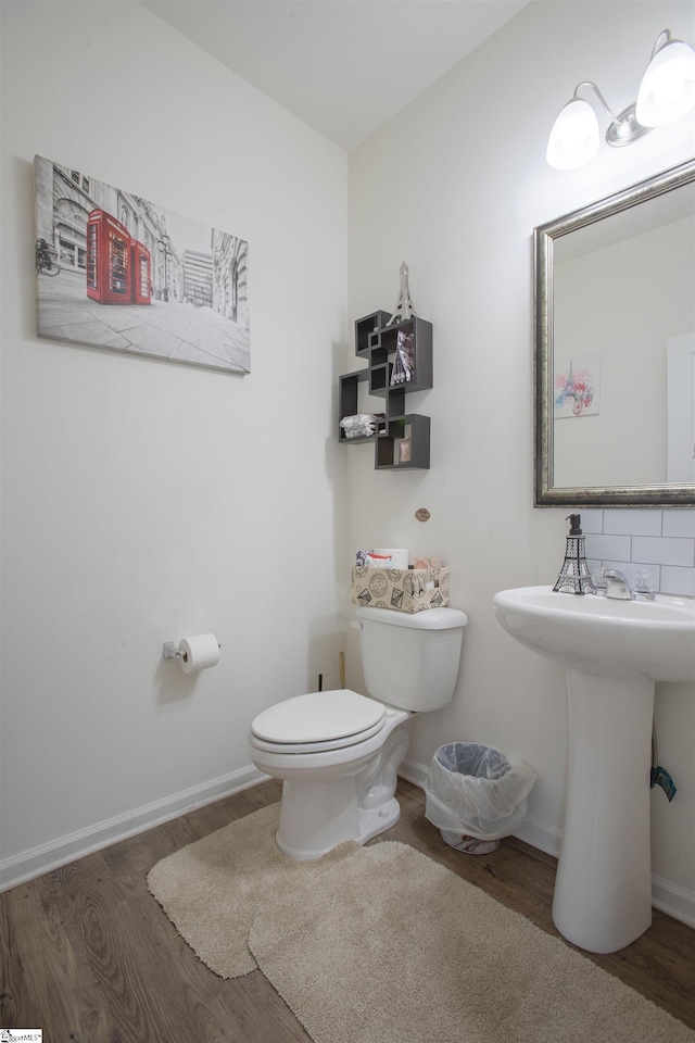 128 Lake Grove Rd, Simpsonville, SC 29681 - half bath featuring tasteful backsplash, wood finished floors, toilet, and baseboards