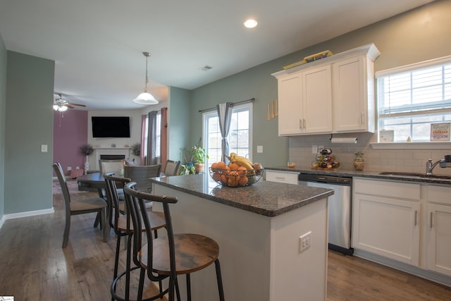 128 Lake Grove Rd, Simpsonville, SC 29681 - kitchen with white cabinets, dishwasher, open floor plan, a fireplace, and a sink