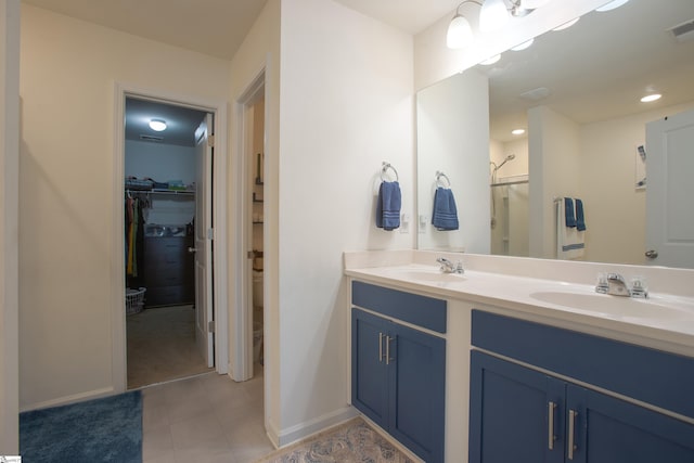 128 Lake Grove Rd, Simpsonville, SC 29681 - bathroom featuring double vanity, a shower with door, a spacious closet, and a sink