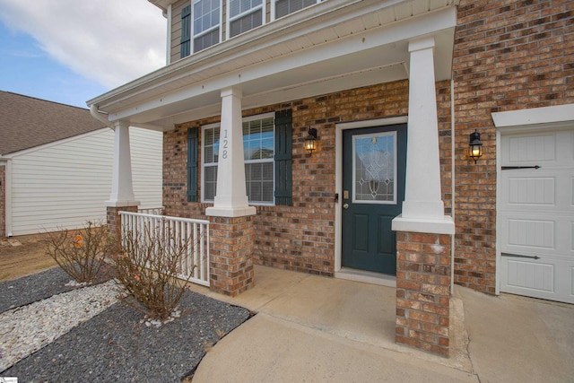 128 Lake Grove Rd, Simpsonville, SC 29681 - entrance to property with an attached garage, brick siding, and a porch