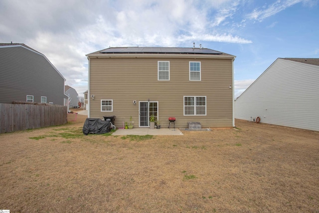 128 Lake Grove Rd, Simpsonville, SC 29681 - rear view of property featuring a patio area, roof mounted solar panels, fence, and a lawn