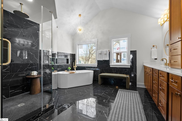 bathroom featuring a marble finish shower, lofted ceiling, a soaking tub, marble finish floor, and vanity