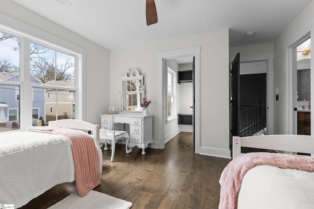 bedroom featuring dark wood-style floors, ceiling fan, and baseboards