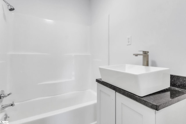 bathroom featuring shower / washtub combination and vanity