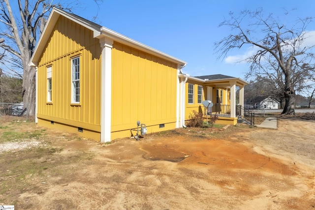 view of property exterior featuring a porch and crawl space