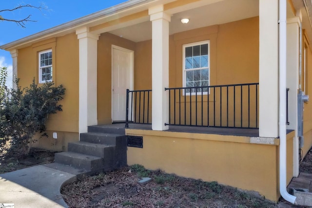 exterior space with covered porch and stucco siding