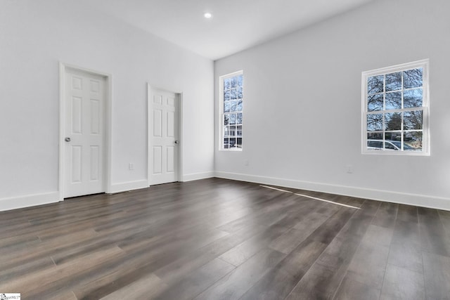 unfurnished bedroom featuring baseboards, dark wood finished floors, and recessed lighting