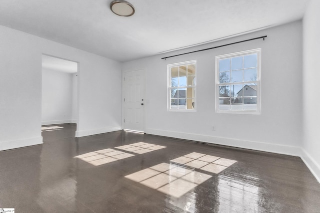 unfurnished room featuring visible vents and baseboards