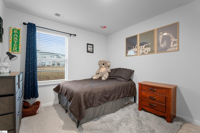 bedroom with baseboards, visible vents, and carpet flooring