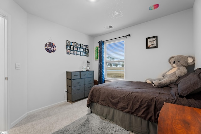 carpeted bedroom featuring visible vents and baseboards