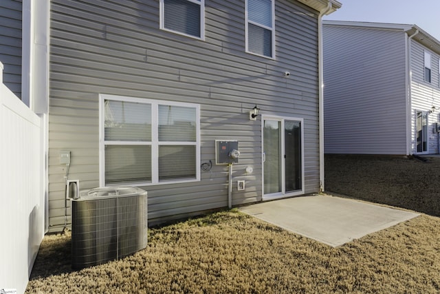 rear view of property featuring a patio area and central AC