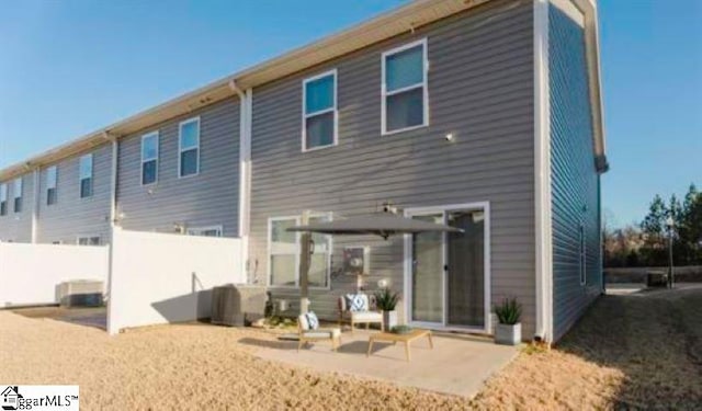 back of property with a patio area and fence