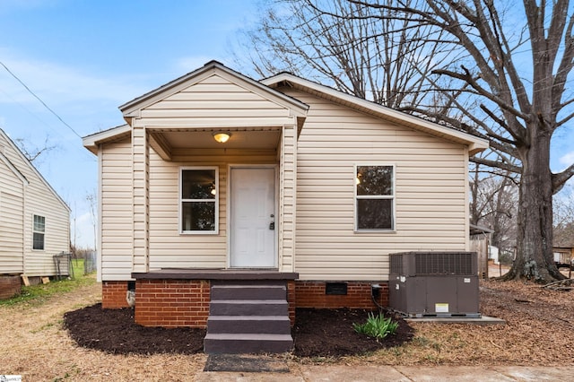 view of front of house with entry steps, crawl space, and cooling unit