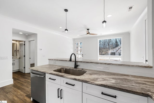 kitchen featuring stone countertops, a sink, white cabinets, stainless steel dishwasher, and pendant lighting