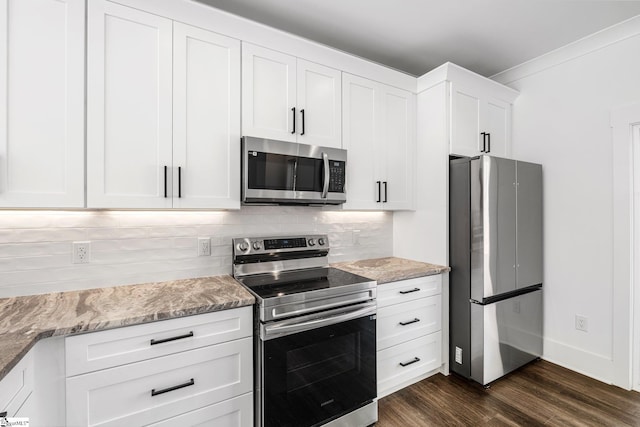 kitchen featuring white cabinetry, appliances with stainless steel finishes, light stone countertops, dark wood-style floors, and tasteful backsplash