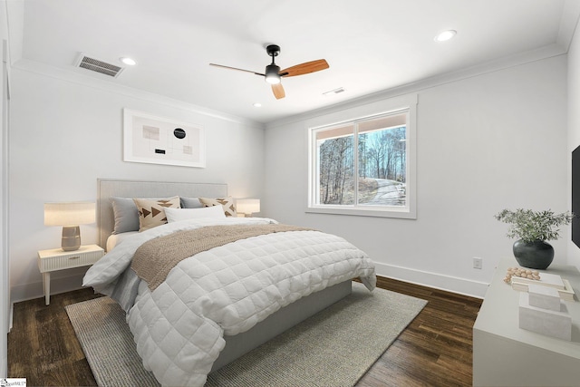 bedroom featuring recessed lighting, visible vents, baseboards, dark wood finished floors, and crown molding