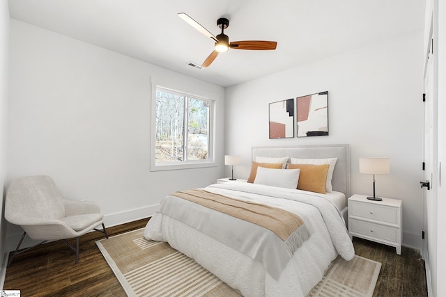 bedroom featuring dark wood-style floors, baseboards, visible vents, and ceiling fan