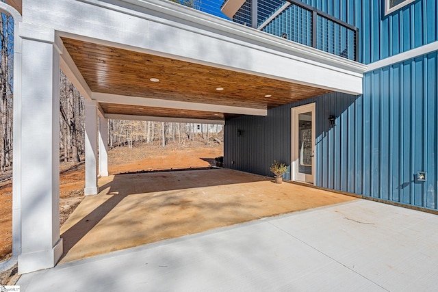 view of patio / terrace with a carport and concrete driveway