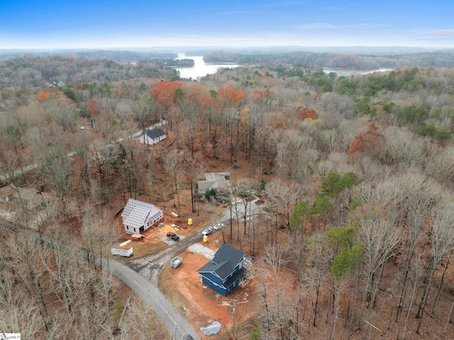 birds eye view of property with a view of trees