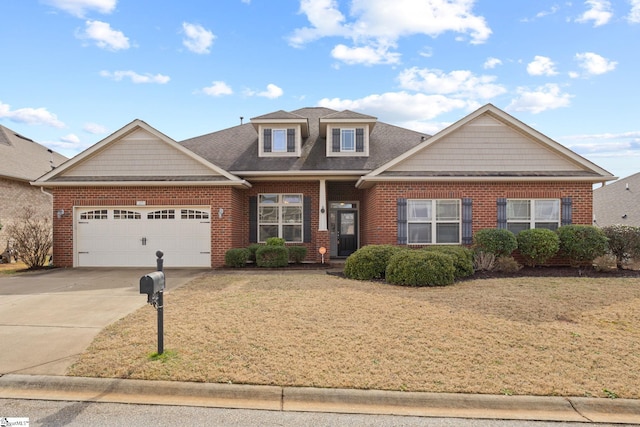 view of front of home featuring a garage, brick siding, driveway, and a front lawn