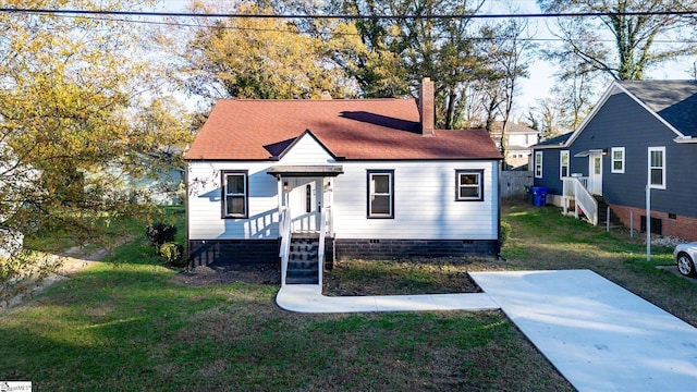 bungalow featuring roof with shingles, a front lawn, crawl space, and a chimney