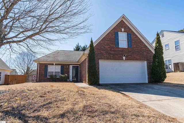 traditional-style home featuring a garage, concrete driveway, brick siding, and fence