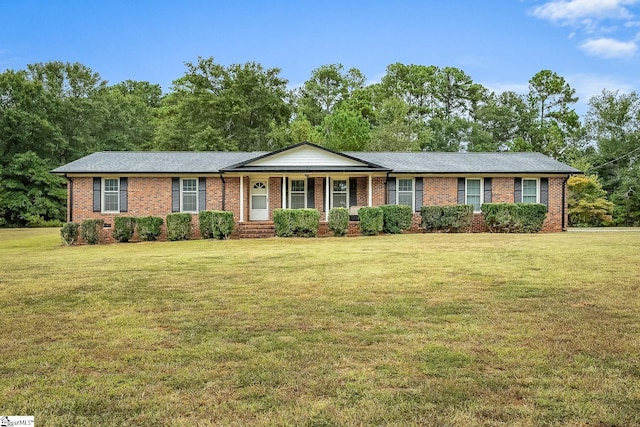 single story home with a porch, a front lawn, and brick siding