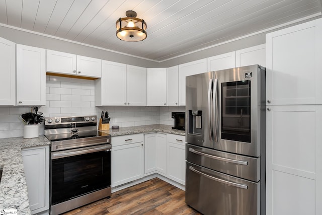 kitchen with stainless steel appliances, light stone counters, decorative backsplash, and white cabinets