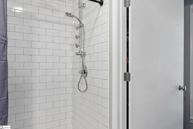 bathroom with a tile shower