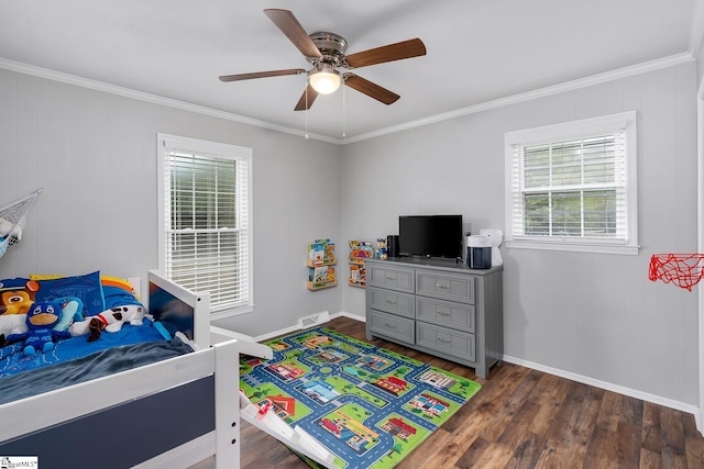 bedroom with dark wood-type flooring, crown molding, and baseboards