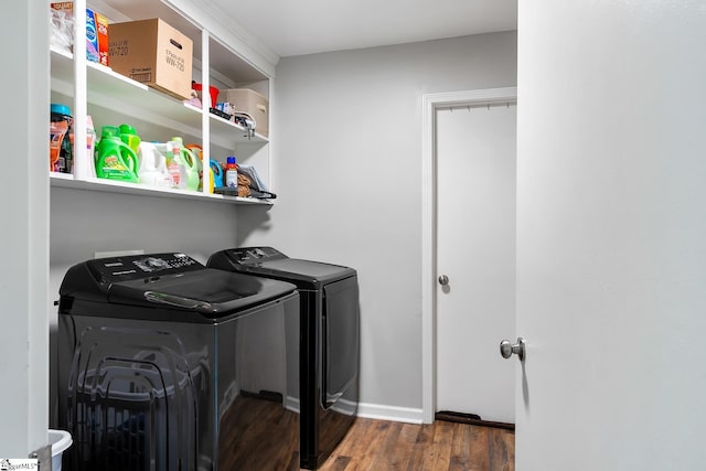 laundry room with laundry area, dark wood-type flooring, washer and clothes dryer, and baseboards