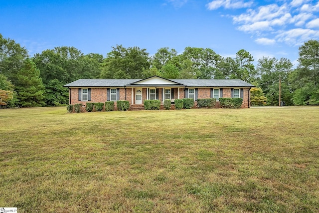 single story home with brick siding and a front yard