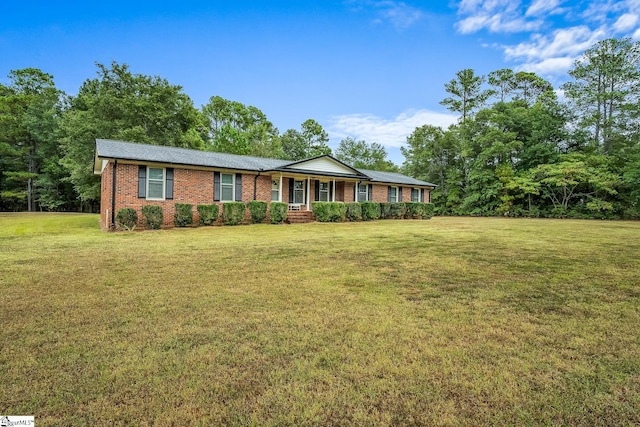 single story home with covered porch, brick siding, and a front yard