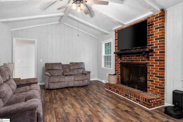 living room featuring lofted ceiling with beams, ceiling fan, dark wood-type flooring, a fireplace, and baseboards