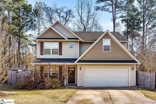 view of front of home featuring driveway, roof with shingles, an attached garage, and fence