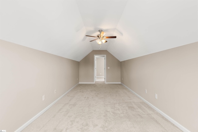 bonus room with lofted ceiling, light colored carpet, ceiling fan, and baseboards