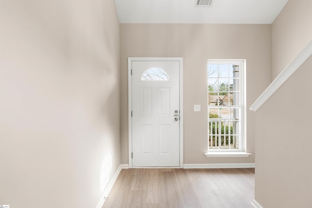 entrance foyer with light wood-style floors, visible vents, and baseboards