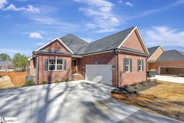 view of front facade featuring an attached garage, cooling unit, brick siding, concrete driveway, and roof with shingles