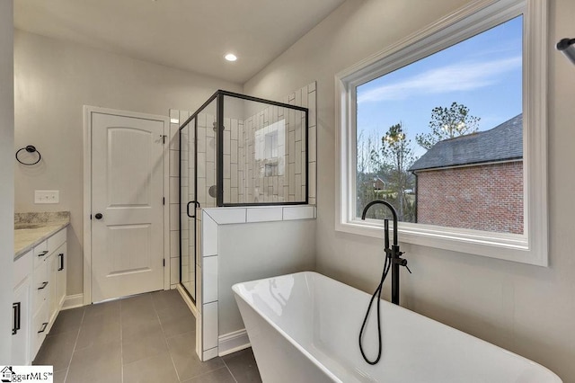 full bath featuring recessed lighting, a soaking tub, vanity, a shower stall, and tile patterned floors